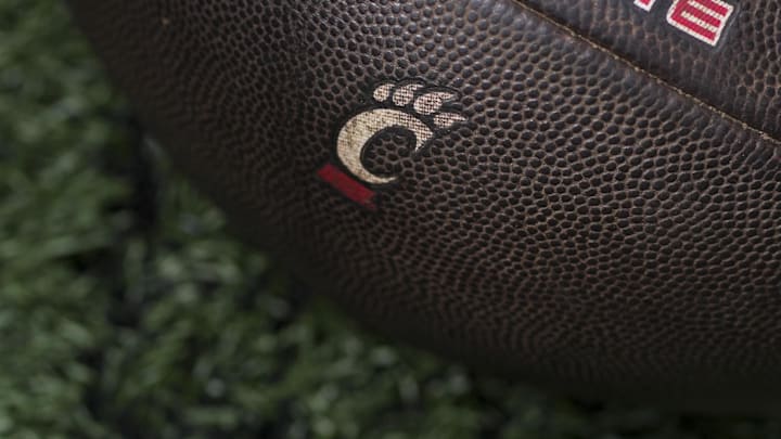 Sep 6, 2025; Cincinnati, Ohio, USA; The Cincinnati logo is seen on a football before the game between the Bowling Green Falcons and the Cincinnati Bearcats at Nippert Stadium. Mandatory Credit: Aaron Doster-Imagn Images