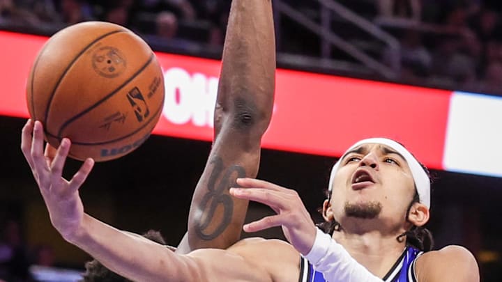 Apr 6, 2026; Orlando, Florida, USA; Orlando Magic guard Anthony Black (0) is fouled by Detroit Pistons forward Paul Reed (7) during the second half at Kia Center. Mandatory Credit: Mike Watters-Imagn Images