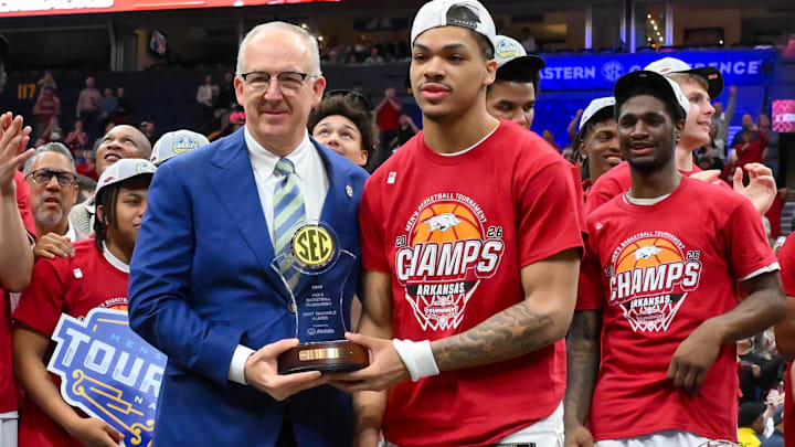 Arkansas guard Darius Acuff Jr. (5) receives the MVP trophy from SEC Commissioner Greg Sankey during the men's SEC Conference Tournament Championship at Bridgestone Arena. Arkansas guard Darius Acuff Jr. (5) receives the MVP trophy from SEC Commissioner Greg Sankey during the men's SEC Conference Tournament Championship at Bridgestone Arena.
