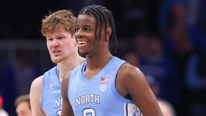 Dec 20, 2025; Atlanta, Georgia, USA; North Carolina Tar Heels forward Caleb Wilson (8) and center Henri Veesaar (13) celebrate during a timeout against the Ohio State Buckeyes in the second half at State Farm Arena. Mandatory Credit: Brett Davis-Imagn Images
