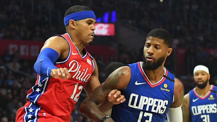 Mar 1, 2020; Los Angeles, California, USA;  Philadelphia 76ers forward Tobias Harris (12) guards Los Angeles Clippers guard Paul George (13) as he drives to the basket in the first half of the game at Staples Center.  Mandatory Credit: Jayne Kamin-Oncea-Imagn Images