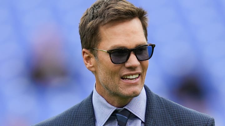 Oct 12, 2025; Baltimore, Maryland, USA; Fox Sports announcer Tom Brady looks on before the game between the Baltimore Ravens and the Los Angeles Rams at M&T Bank Stadium. Mandatory Credit: Mitch Stringer-Imagn Images Oct 12, 2025; Baltimore, Maryland, USA; Fox Sports announcer Tom Brady looks on before the game between the Baltimore Ravens and the Los Angeles Rams at M&T Bank Stadium. Mandatory Credit: Mitch Stringer-Imagn Images