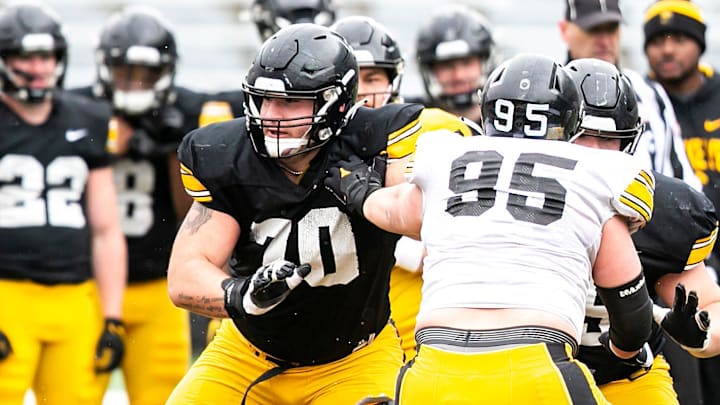 Iowa offensive lineman Beau Stephens (70) and center Logan Jones block against defensive lineman Aaron Graves (95) during the Hawkeyes' final spring NCAA football practice, Saturday, April 22, 2023, at Kinnick Stadium in Iowa City, Iowa.

230422 Iowa Spring Fb 104 Jpg