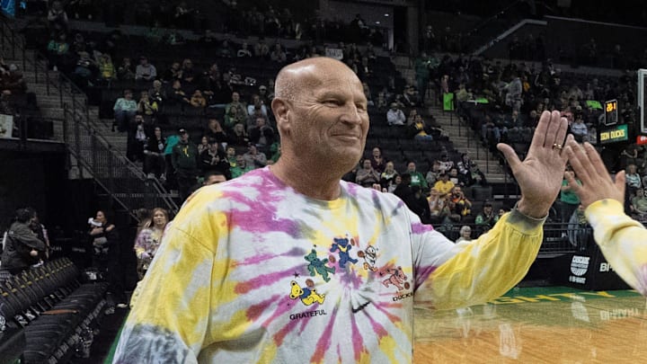 Oregon coach Kelly Graves, left, high-fives Sofia Bell before the game against Washington at Matthew Knight Arena in Eugene, March 1, 2026.