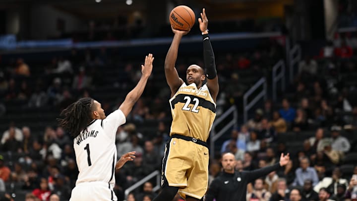 Nov 16, 2025; Washington, District of Columbia, USA;  Washington Wizards forward Khris Middleton (22) attempts a jump shot over Brooklyn Nets forward Ziaire Williams (1) during the fourth quarter at Capital One Arena. Mandatory Credit: Rafael Suanes-Imagn Images
