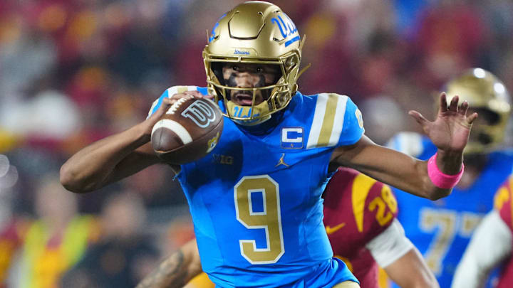 Nov 29, 2025; Los Angeles, California, USA; UCLA Bruins quarterback Nico Iamaleava (9) carries the ball against the Southern California Trojans in the first half at United Airlines Field at Los Angeles Memorial Coliseum. Mandatory Credit: Kirby Lee-Imagn Images