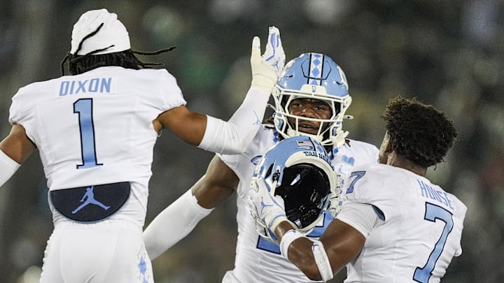 Sep 6, 2025; Charlotte, North Carolina, USA; North Carolina Tar Heels defensive back Greg Smith (12) celebrates his interception with teammates during the second half against the Charlotte 49ers at Jerry Richardson Stadium. Mandatory Credit: Jim Dedmon-Imagn Images Sep 6, 2025; Charlotte, North Carolina, USA; North Carolina Tar Heels defensive back Greg Smith (12) celebrates his interception with teammates during the second half against the Charlotte 49ers at Jerry Richardson Stadium. Mandatory Credit: Jim Dedmon-Imagn Images