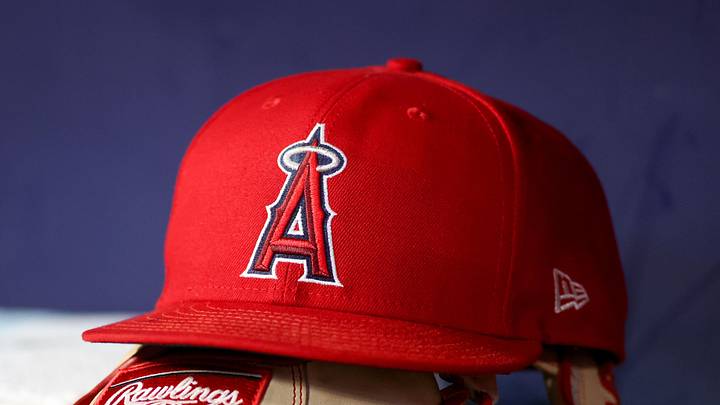 A detailed view of a Los Angeles Angels hat and glove on the bench against the Atlanta Braves in the eighth inning at Truist Park on Aug. 1, 2023.