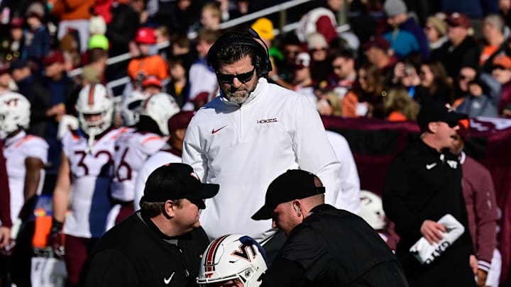 College football coach Brent Pry checks on an injured wide receiver