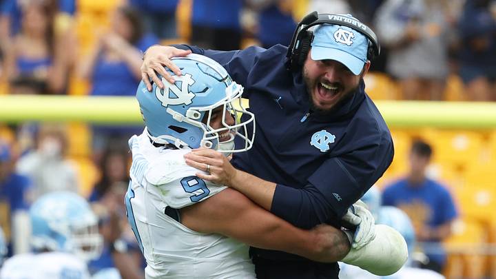 Oct 10, 2026; Pittsburgh, Pennsylvania, USA; North Carolina Tar Heels defensive lineman Melkart Abou Jaoude (9) celebrates with outside linebackers Coach Ty Nichols (right) after a defensive stop against the Pittsburgh Panthers during the fourth quarter at Acrisure Stadium. Mandatory Credit: Charles LeClaire-Imagn Images Oct 10, 2026; Pittsburgh, Pennsylvania, USA; North Carolina Tar Heels defensive lineman Melkart Abou Jaoude (9) celebrates with outside linebackers Coach Ty Nichols (right) after a defensive stop against the Pittsburgh Panthers during the fourth quarter at Acrisure Stadium. Mandatory Credit: Charles LeClaire-Imagn Images