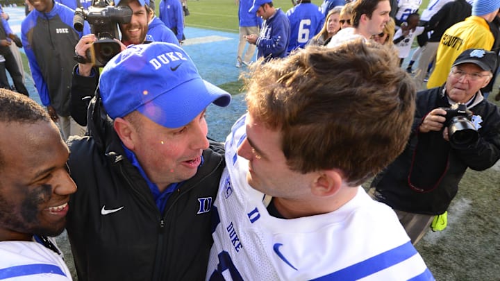 Nov 30, 2013; Chapel Hill, NC, USA;  Duke Blue Devils quarterbacks Anthony Boone (7) and Brandon Connette (18) with quarterbacks coach Kurt Roper after the game. The Blue Devils defeated the North Carolina Tar Heels 27-25 at Kenan Memorial Stadium. Mandatory Credit: Bob Donnan-Imagn Images