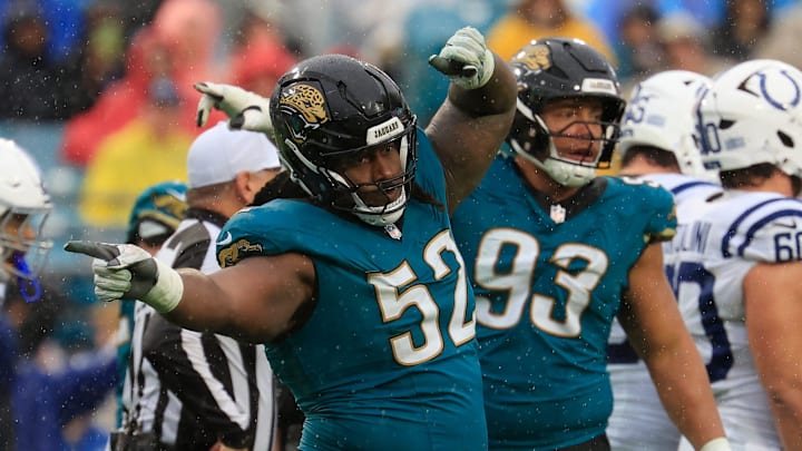 Jacksonville Jaguars defensive tackle DaVon Hamilton (52) signals a turnover near teammate defensive end Matt Dickerson (93) during the fourth quarter of an NFL football game at EverBank Stadium, Sunday, Dec. 7, 2025, in Jacksonville, Fla. The Jaguars defeated the Colts 36-19.