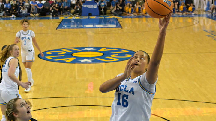 Feb 1, 2026; Los Angeles, California, USA;  UCLA Bruins forward Sienna Betts (16) drives past Iowa Hawkeyes center Layla Hays (12) for a basket in the first half at Pauley Pavilion presented by Wescom Financial. Mandatory Credit: Jayne Kamin-Oncea-Imagn Images