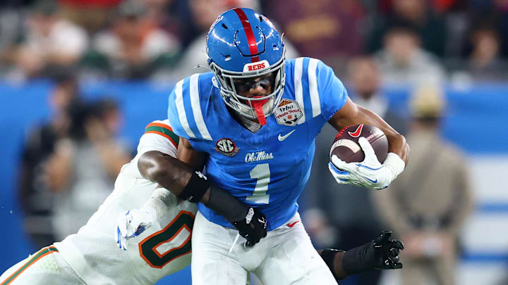 Jan 8, 2026; Glendale, AZ, USA;Mississippi Rebels wide receiver De'zhaun Stribling (1) makes a catch against Miami Hurricanes defensive back Keionte Scott (0)  in the second half during the 2026 Fiesta Bowl and semifinal game of the College Football Playoff at State Farm Stadium. 
