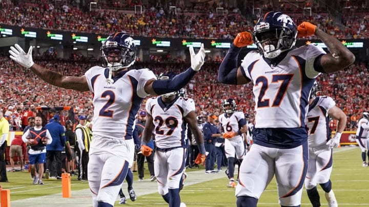 Oct 12, 2023; Kansas City, Missouri, USA; Denver Broncos safety Justin Simmons (31) and cornerback Pat Surtain II (2) and cornerback Damarri Mathis (27) celebrate after Simmon   s interception against the Kansas City Chiefs during the first half at GEHA Field at Arrowhead Stadium. Mandatory Credit: Denny Medley-USA TODAY Sports