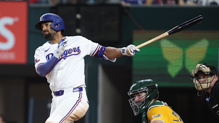 Apr 29, 2025; Arlington, Texas, USA; Texas Rangers second baseman Marcus Semien singles in a run during the sixth inning against the Oakland Athletics at Globe Life Field. Mandatory Credit: Tim Heitman-Imagn Images