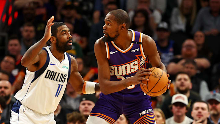 Dec 27, 2024; Phoenix, Arizona, USA; Phoenix Suns forward Kevin Durant (35) handles the ball against Dallas Mavericks guard Kyrie Irving (11) during the third quarter at Footprint Center. Mandatory Credit: Mark J. Rebilas-Imagn Images