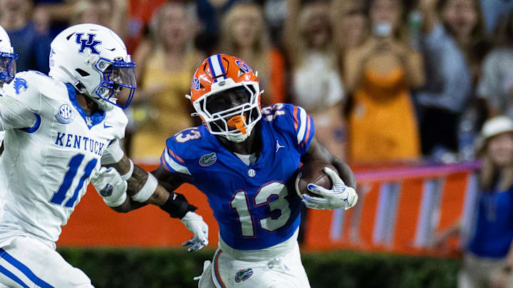 Oct 19, 2024; Gainesville, Florida, USA; Florida Gators running back Jadan Baugh (13) runs past Kentucky Wildcats defensive back Zion Childress (11) during the first half at Ben Hill Griffin Stadium. Mandatory Credit: Matt Pendleton-Imagn Images Oct 19, 2024; Gainesville, Florida, USA; Florida Gators running back Jadan Baugh (13) runs past Kentucky Wildcats defensive back Zion Childress (11) during the first half at Ben Hill Griffin Stadium. Mandatory Credit: Matt Pendleton-Imagn Images