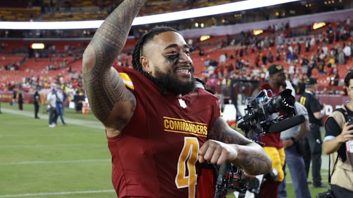 Oct 20, 2024; Landover, Maryland, USA; Washington Commanders linebacker Frankie Luvu (4) celebrates while leaving the field after the game against the Carolina Panthers at Northwest Stadium. Mandatory Credit: Geoff Burke-Imagn Images