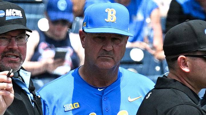 Jun 14, 2025; Omaha, Neb, USA;  Murray State Racers head coach Dan Skirka and UCLA Bruins head coach John Savage meet with umpires before the game at Charles Schwab Field. Mandatory Credit: Steven Branscombe-Imagn Images