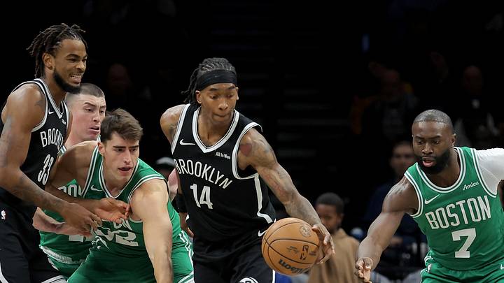 Nov 18, 2025; Brooklyn, New York, USA; Brooklyn Nets guard Terance Mann (14) controls the ball against Boston Celtics center Luka Garza (52) and guard Jaylen Brown (7) during the first quarter at Barclays Center. Mandatory Credit: Brad Penner-Imagn Images