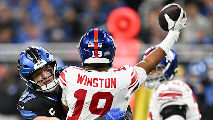 New York Giants quarterback Jameis Winston (19) is hit by Detroit Lions edge Aidan Hutchinson (97) 