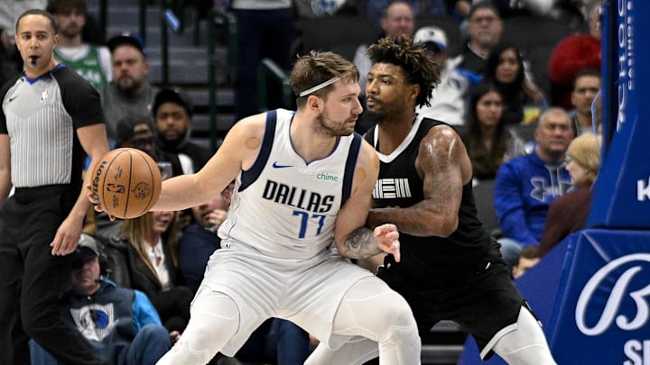 Jan 9, 2024; Dallas, Texas, USA; Dallas Mavericks guard Luka Doncic (77) looks to move to the basket past Memphis Grizzlies guard Marcus Smart (36) during the second half at the American Airlines Center. Mandatory Credit: Jerome Miron-Imagn Images
