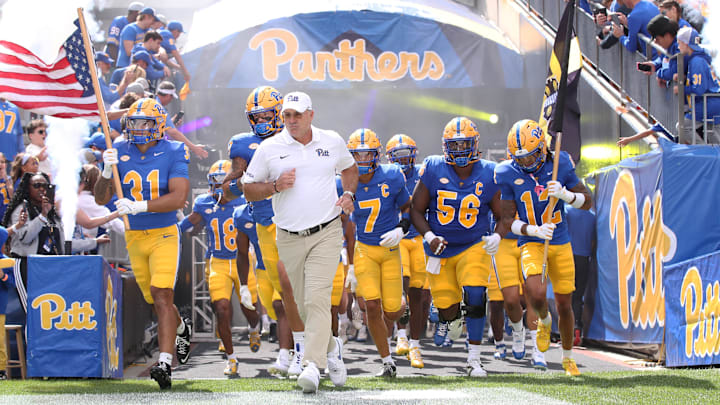 Aug 30, 2025; Pittsburgh, Pennsylvania, USA; Pittsburgh Panthers head coach Pat Narduzzi (middle) leads the team onto the field to play the Duquesne Dukes at Acrisure Stadium. Mandatory Credit: Charles LeClaire-Imagn Images