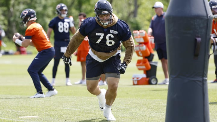 Teven Jenkins approaches the blocking dummy on a pass play drill during minicamp. Jenkins is the top Bears player without a contract for 2025.