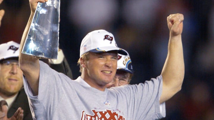 Tampa Bay Buccaneers head coach Jon Gruden holds up the Vince Lombardi Trophy after winning Super Bowl XXXVIII.