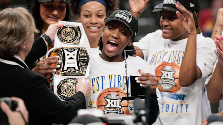 Mar 8, 2026; Kansas City, MO, USA; West Virginia Mountaineers guard Jordan Harrison (10) accepts the player of the game trophy after the game against the TCU Horned Frogs at T-Mobile Center. Mandatory Credit: William Purnell-Imagn Images