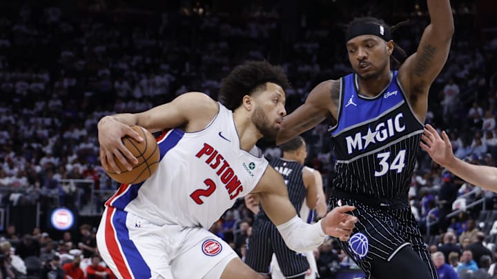 Apr 22, 2026; Detroit, Michigan, USA; Detroit Pistons guard Cade Cunningham (2) dribbles defended by Orlando Magic center Wendell Carter Jr. (34) and forward Franz Wagner (22) in the second half during game two of the first round of the 2026 NBA Playoffs at Little Caesars Arena. Mandatory Credit: Rick Osentoski-Imagn Images