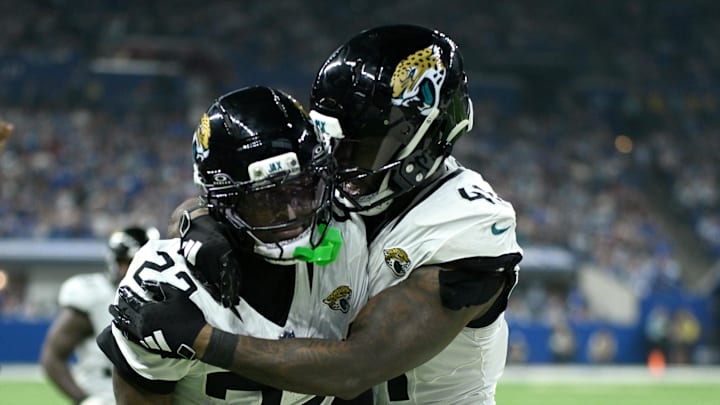 Dec 28, 2025; Indianapolis, Indiana, USA; Jacksonville Jaguars cornerback Jarrian Jones (22) celebrates with defensive end Josh Hines-Allen (41) after an interception during the second half against the Indianapolis Colts at Lucas Oil Stadium. Mandatory Credit: Robert Goddin-Imagn Images