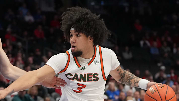 Mar 12, 2026; Charlotte, NC, USA; Miami (FL) Hurricanes guard Tre Donaldson (3) with the ball as Louisville Cardinals guard Isaac McKneely (10) defends in the second half at Spectrum Center. Mandatory Credit: Bob Donnan-Imagn Images