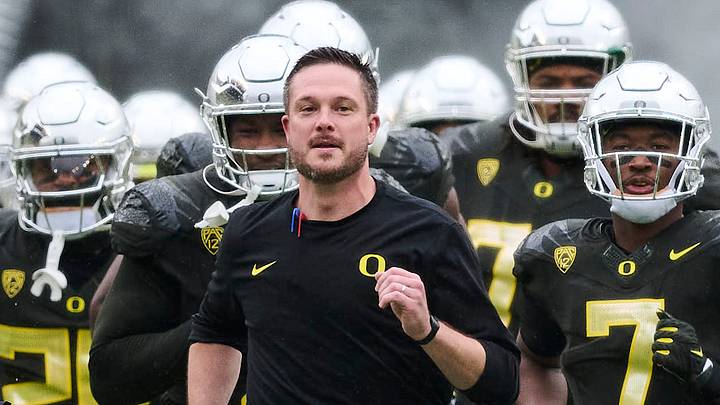 Nov 4, 2023; Eugene, Oregon, USA; Oregon Ducks head coach Dan Lanning runs out to the field with players before a game against the California Golden Bears at Autzen Stadium. Mandatory Credit: Troy Wayrynen-Imagn Images