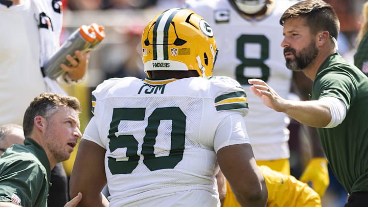 Green Bay Packers offensive tackle Zach Tom (50) is attended to by medical personnel after he was injured at Cleveland. Green Bay Packers offensive tackle Zach Tom (50) is attended to by medical personnel after he was injured at Cleveland.