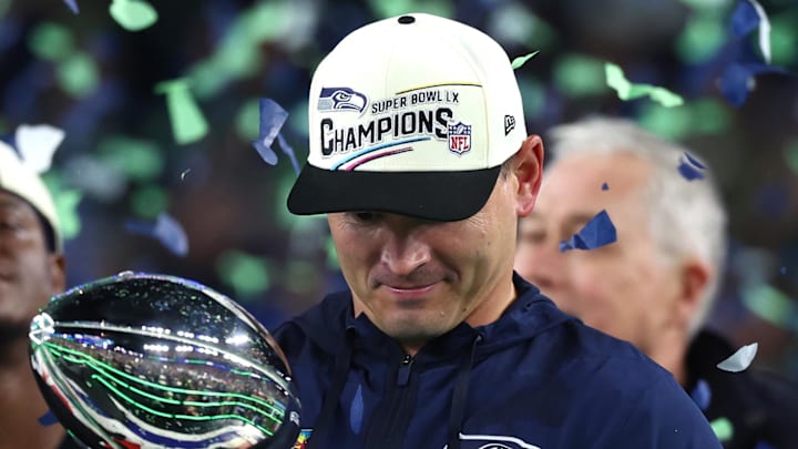 Feb 8, 2026; Santa Clara, CA, USA; Seattle Seahawks head coach Mike MacDonald celebrates with the Vince Lombardi trophy on the podium after defeating the New England Patriots in Super Bowl LX at Levi's Stadium. Mandatory Credit: Mark J. Rebilas-Imagn Images