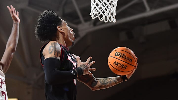 Feb 5, 2025; Chestnut Hill, Massachusetts, USA; Louisville Cardinals guard Terrence Edwards Jr. (5) drives to the basket past Boston College Eagles guard Joshua Beadle (7) during the first half at Conte Forum. Feb 5, 2025; Chestnut Hill, Massachusetts, USA; Louisville Cardinals guard Terrence Edwards Jr. (5) drives to the basket past Boston College Eagles guard Joshua Beadle (7) during the first half at Conte Forum.