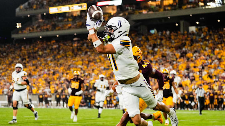 Aug 30, 2025; Tempe, Arizona, USA; Northern Arizona Lumberjacks wide receiver Kolbe Katsis (11) drops a pass under pressure during the first quarter of the game between Arizona State Sun Devils and Northern Arizona Lumberjacks at Mountain America Stadium. 