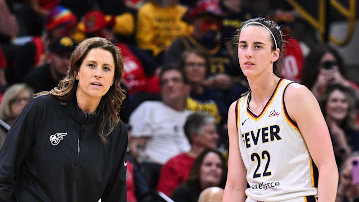 May 4, 2025; Iowa City, IA, USA; Indiana Fever guard Caitlin Clark (22) looks on with head coach Stephanie White during the third quarter against the Brazil National Team at Carver-Haweye Arena. Mandatory Credit: Jeffrey Becker-Imagn Images