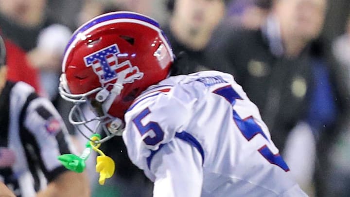 Dec 28, 2024; Shreveport, LA, USA; Army Black Knights running back Noah Short (15) tries to avoid a hit from Louisiana Tech Bulldogs defensive back Michael Richard (5) during the first half of the Radiance Technologies Independence Bowl at Independence Stadium. Mandatory Credit: Danny Wild-Imagn Images