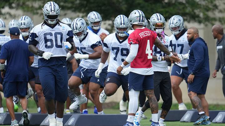 Dallas Cowboys quarterback Dak Prescott leads teammates through a drill during practice at the Ford Center.