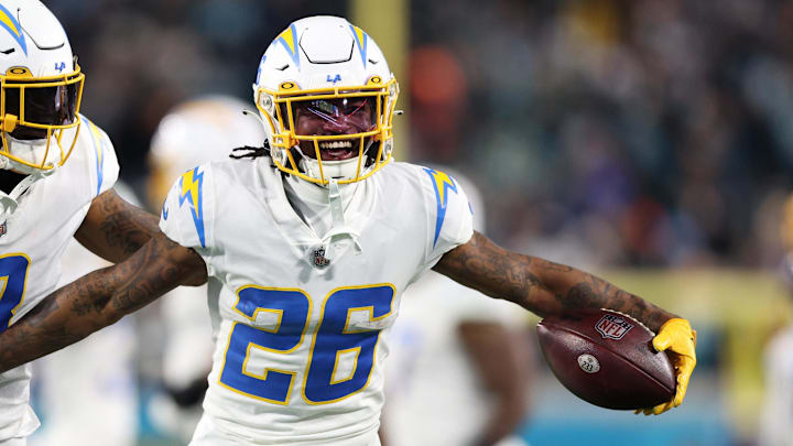 Jan 14, 2023; Jacksonville, Florida, USA; Los Angeles Chargers cornerback Asante Samuel Jr. (26) celebrates with safety Derwin James Jr. (3) after an interception during the second quarter of a wild card game against the Jacksonville Jaguars at TIAA Bank Field. Mandatory Credit: Nathan Ray Seebeck-Imagn Images