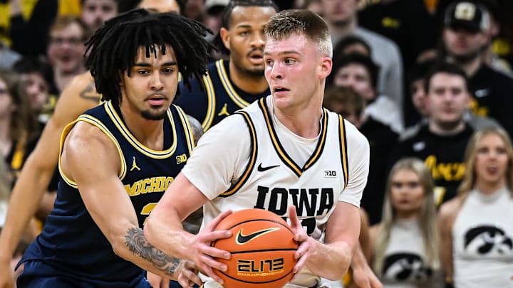 Mar 5, 2026; Iowa City, Iowa, USA; Iowa Hawkeyes guard Bennett Stirtz (14) is defended by Michigan Wolverines guard Elliot Cadeau (3) during the first half at Carver-Hawkeye Arena. Mandatory Credit: Jeffrey Becker-Imagn Images