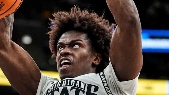 Michigan State forward Coen Carr (55) dunks against UCLA forward Eric Dailey Jr. (3) during the second half of Big Ten tournament quarterfinal at United Center in Chicago on Friday, March 13, 2026.