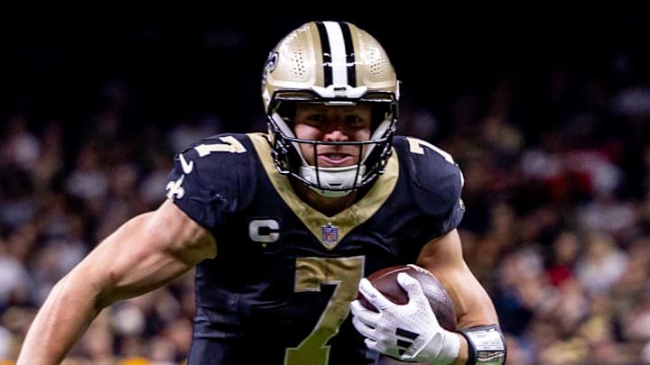 Nov 17, 2024; New Orleans, Louisiana, USA;  New Orleans Saints tight end Taysom Hill (7) avoids the tackle of Cleveland Browns safety Ronnie Hickman (33) during the second half at Caesars Superdome. Mandatory Credit: Stephen Lew-Imagn Images