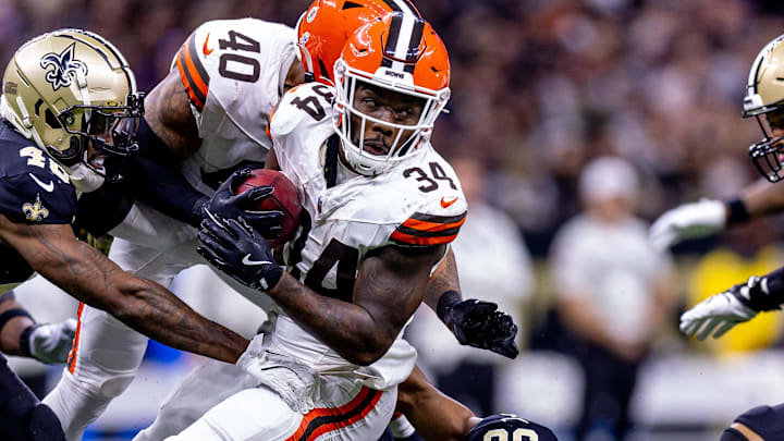 Nov 17, 2024; New Orleans, Louisiana, USA;  Cleveland Browns running back Jerome Ford (34) is tackled by New Orleans Saints linebacker Anfernee Orji (58) during the second half at Caesars Superdome. Mandatory Credit: Stephen Lew-Imagn Images