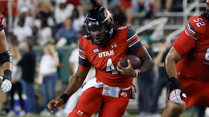 Utah Utes quarterback Devon Dampier (4) carries the ball against the Baylor Bears during the first half at McLane Stadium. 