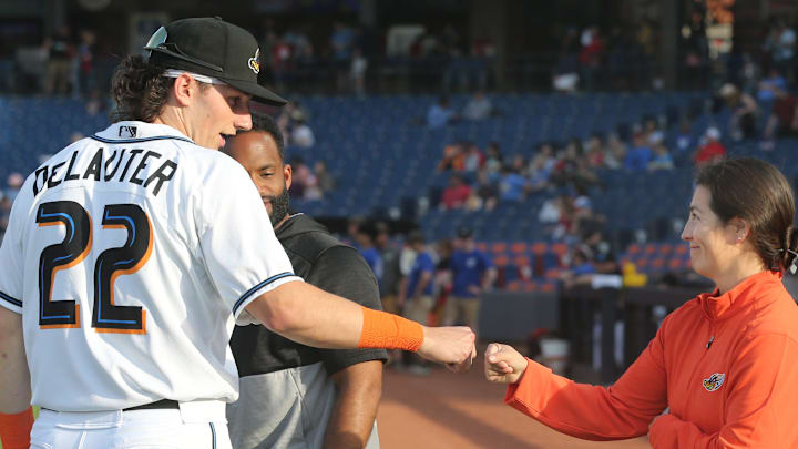 Akron RubberDucks assistant athletic trainer Karina Gonzalez gets a first bump from Chase DeLauter before the game against Erie on Tuesday, April 16, 2024, in Akron, Ohio. [Phil Masturzo/ Beacon Journal]