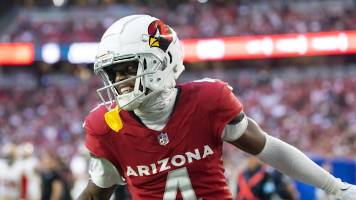 Jan 5, 2025; Glendale, Arizona, USA; Arizona Cardinals wide receiver Greg Dortch (4) celebrates after scoring a touchdown against the San Francisco 49ers in the second half at State Farm Stadium. Mandatory Credit: Mark J. Rebilas-Imagn Images